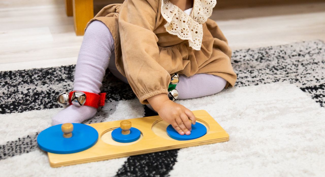 幼児教具のはめ込み図形で遊ぶ女児